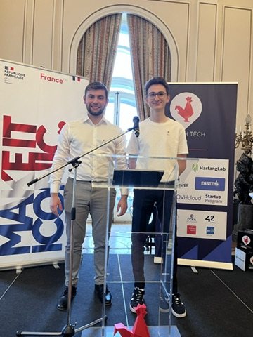 The two Ablatic co-founders stand behind a glass lectern in front of la French Tech and sponsor banners.